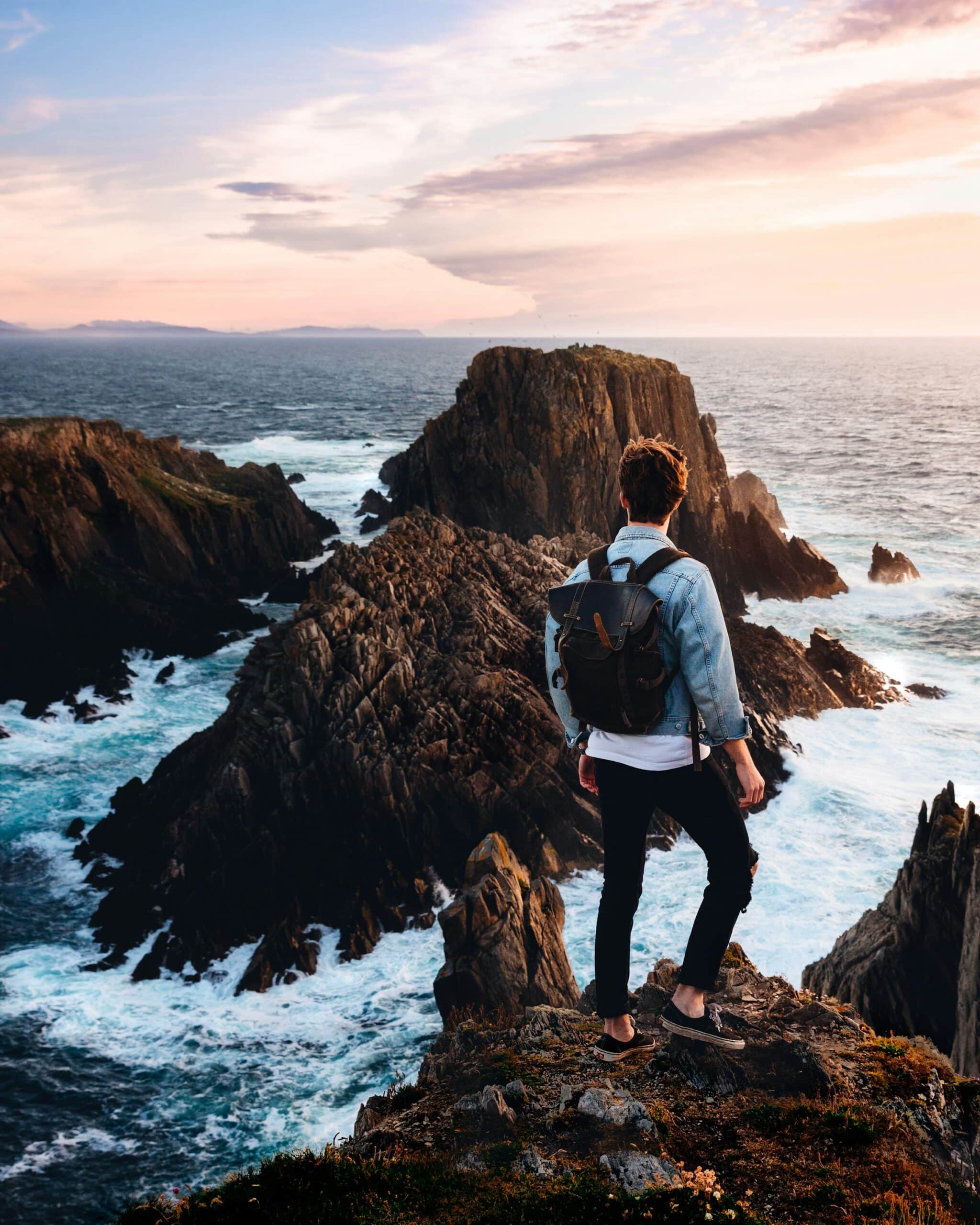 wellthy man overlooking rocky shoreline