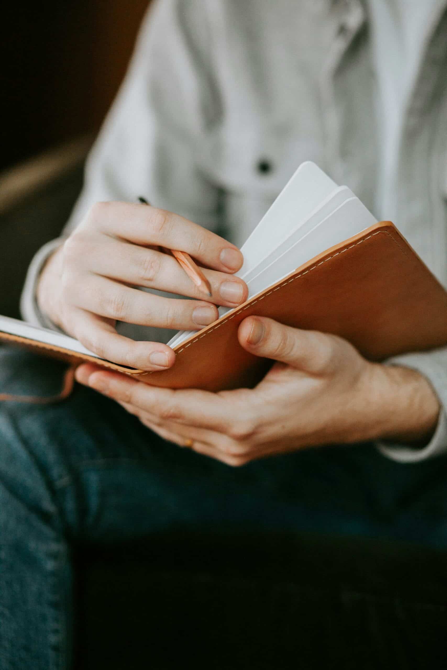 Man reflecting on clarity in journal